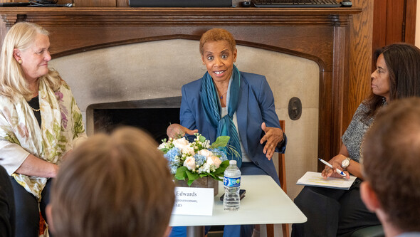 Ann Marie Buerkle and Donna Edwards seated in front of a fireplace