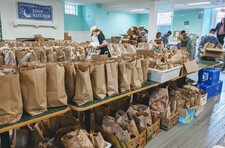 Rows of brown paper grocery bags on a shelf