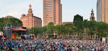 An aerial shot of the New Haven Green packed with visitors enjoying an outdoor concert.