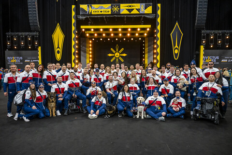 Team U.S. at the Invictus Games opening ceremony A group of about 50 people wearing red, white, and blue uniforms pose for a group photo