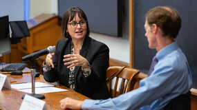 Professor Cristina Rodriguez speaking to New Haven mayor Justin Elicker