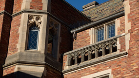 Windows and a stone railing on the brick facade of Sterling Law Building